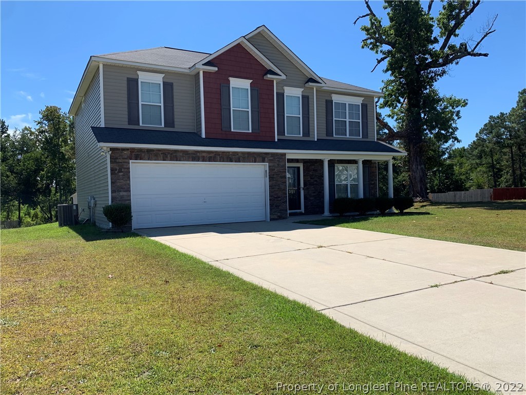 351 United Road Raeford, NC 28376 - Photo 2 of 4 a front view of a house with a yard and garage