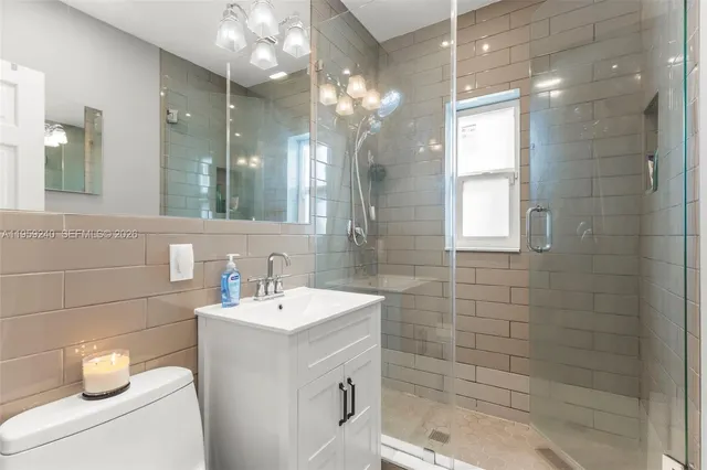 a bathroom with a sink a toilet and a mirror