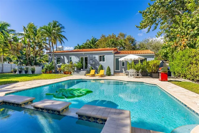 a view of a swimming pool with an outdoor seating and a yard