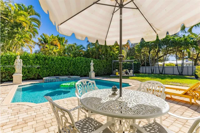 a swimming pool with outdoor seating and yard