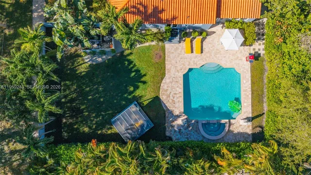 an aerial view of a house with garden space and street view