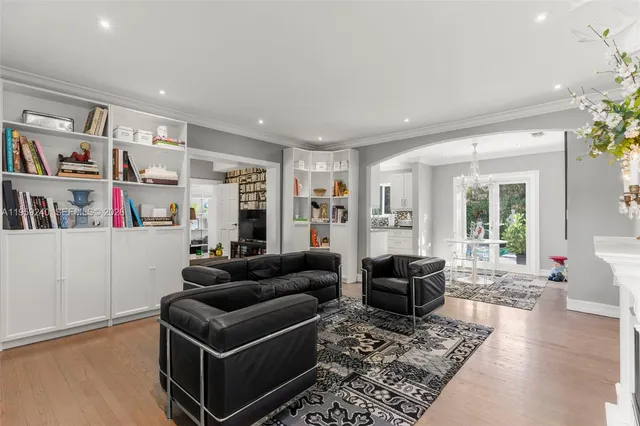 a living room with furniture and a book shelf
