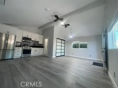 a view of kitchen with sink microwave and refrigerator