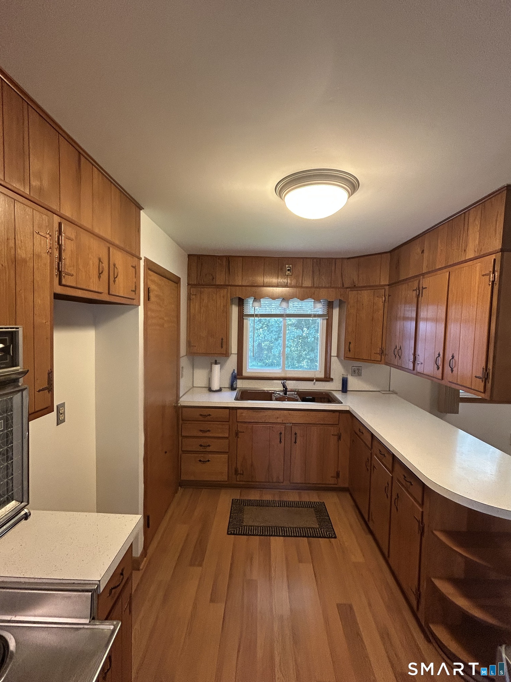 13 Walnut Lane Wallingford, CT 06492 - Photo 5 of 27 a kitchen with a sink and wooden floor