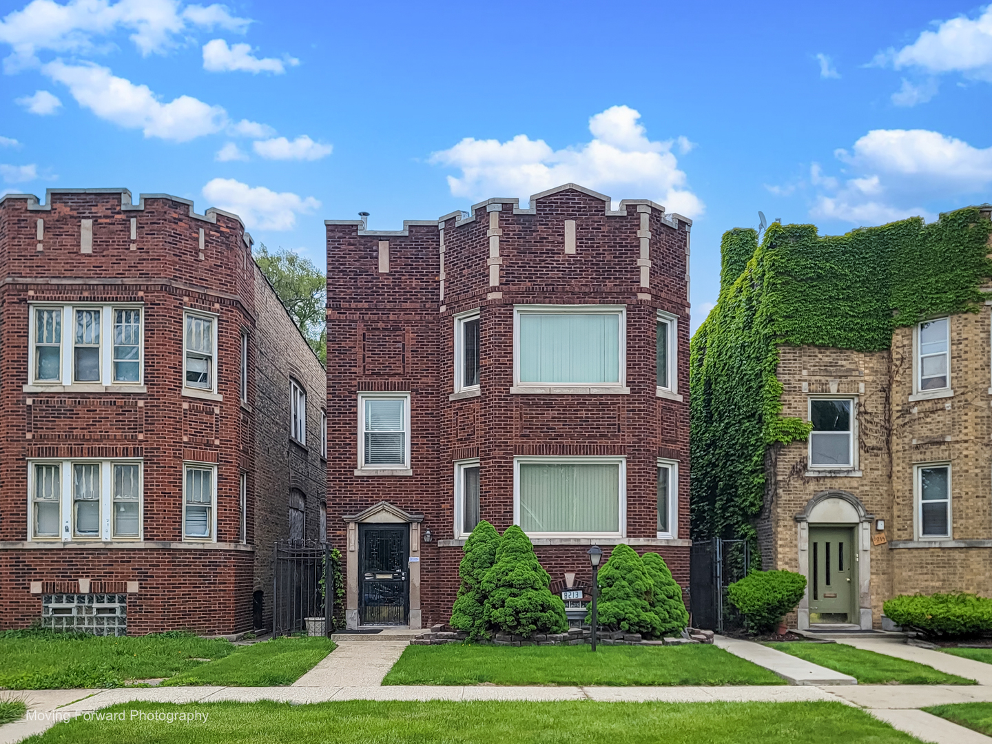 8213 South Indiana Avenue Chicago, IL 60619 - Photo 2 of 25 a view of a brick building next to a yard