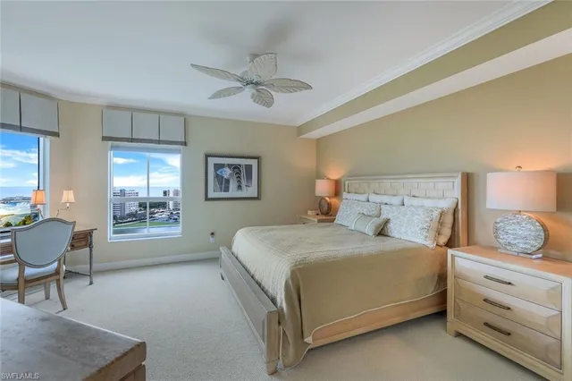 a bedroom with a bed a chair and painting on the wall