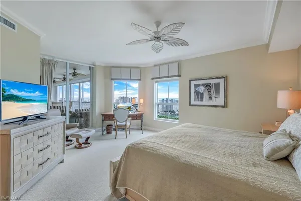 a bedroom with furniture and a flat screen tv