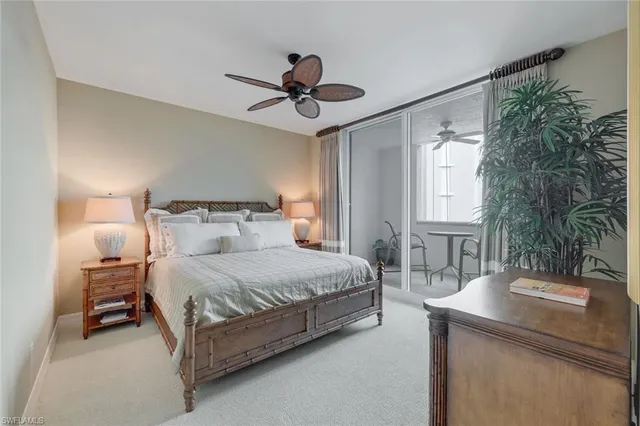 a bedroom with a bed a chandelier and a window