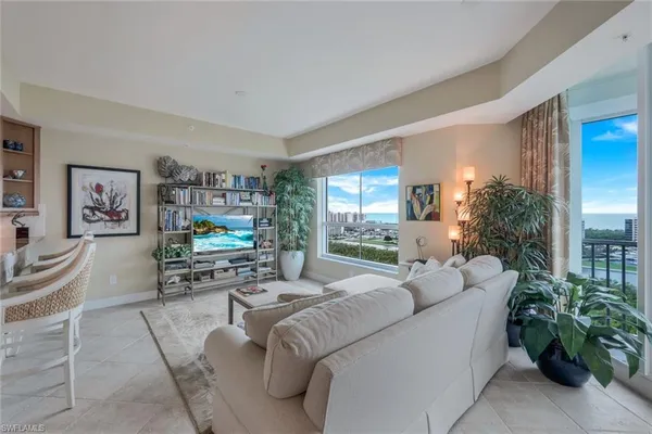 a living room with furniture and a potted plant