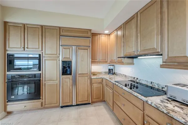 a kitchen with a stove and a refrigerator