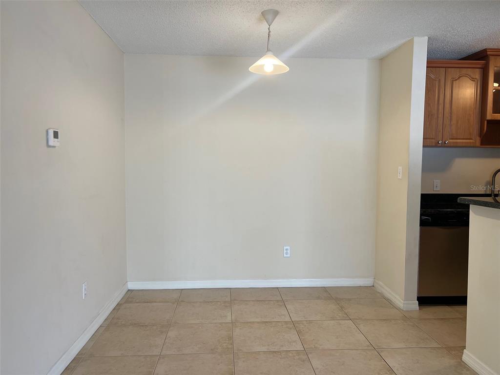 455 Alt 19, Unit 159 Palm Harbor, FL 34683 - Photo 10 of 26 a view of an empty room with wooden floor and a window