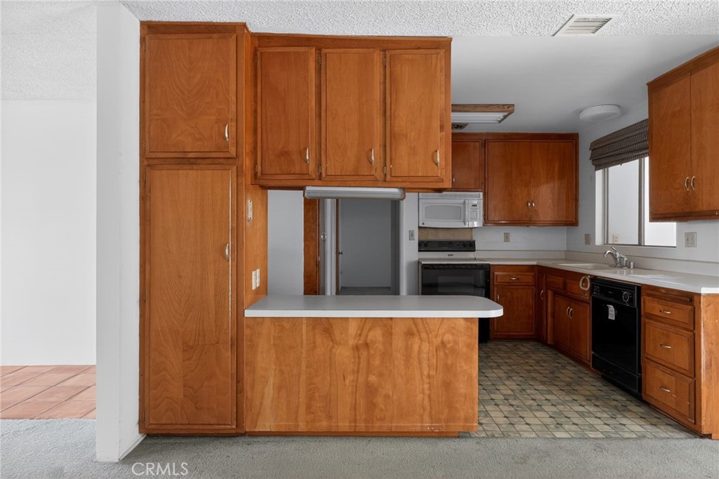 11675 Calvin Street Yucaipa, CA 92399 - Photo 22 of 30 a kitchen with stainless steel appliances granite countertop a refrigerator a sink and dishwasher
