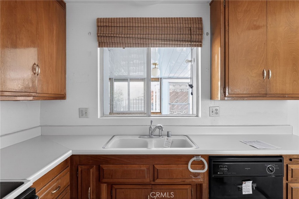 11675 Calvin Street Yucaipa, CA 92399 - Photo 24 of 30 a view of a kitchen sink dishwasher and cabinets