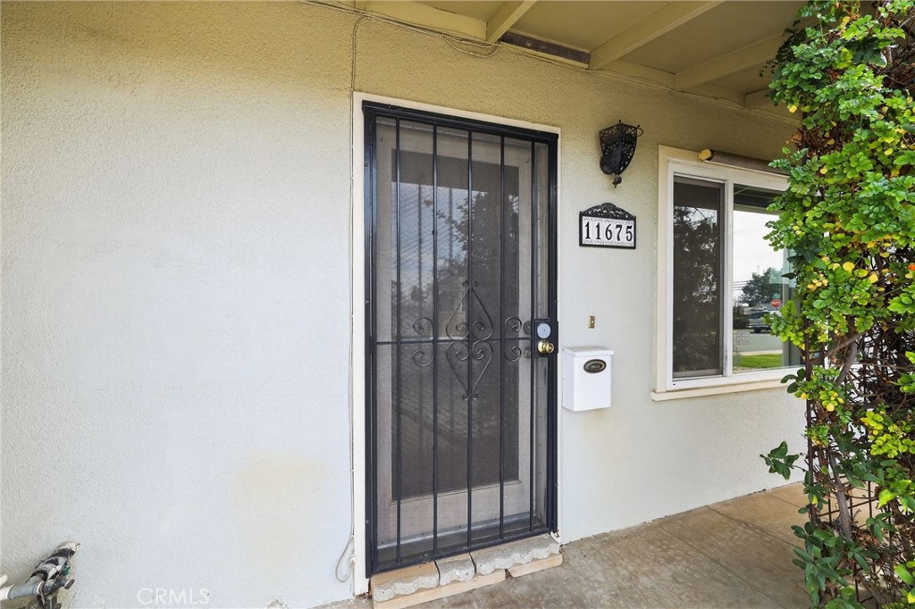 11675 Calvin Street Yucaipa, CA 92399 - Photo 6 of 30 a front view of a house with a door