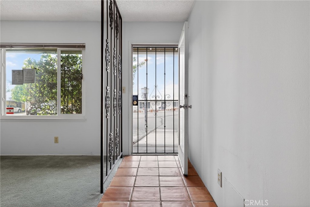 11675 Calvin Street Yucaipa, CA 92399 - Photo 8 of 30 a view of a room with wooden floor and windows