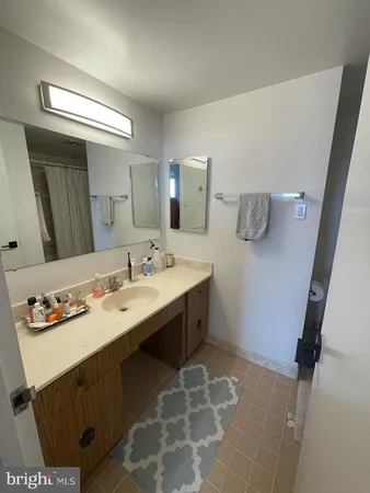 a spacious bathroom with a bathtub sink and mirror