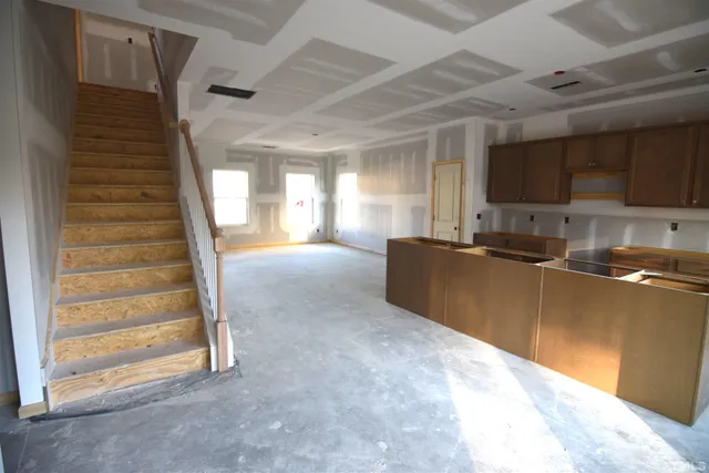 a view of a kitchen with a sink a refrigerator and a window