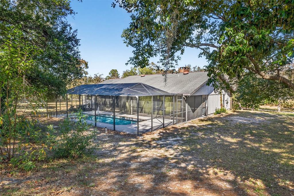 14252 Trinity Road Brooksville, FL 34614 - Photo 18 of 26 a view of a house with a yard
