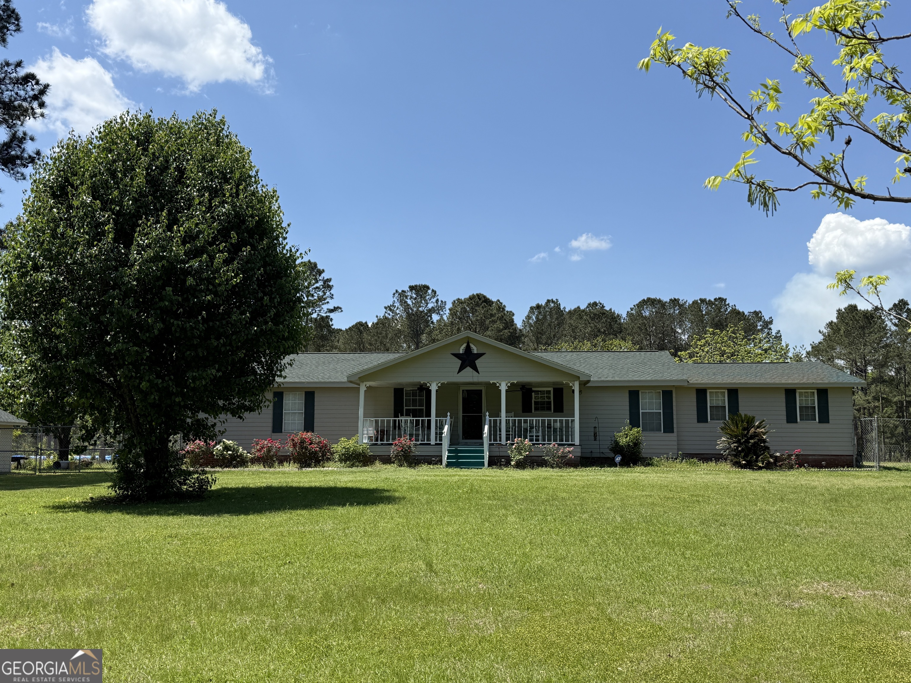 13995 Ollifftown Road Metter, GA 30439 - Photo 1 of 1 a front view of a house with a garden