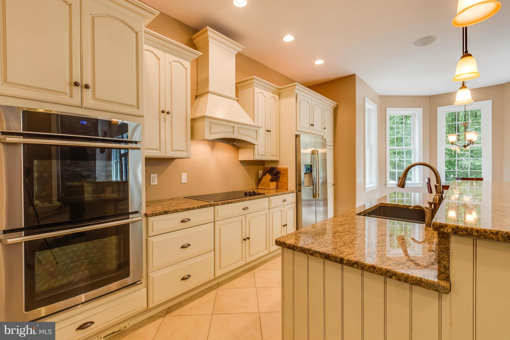 19385 Country Road Beaverdam, VA 23015 - Photo 7 of 30 a kitchen with granite countertop white cabinets and stainless steel appliances