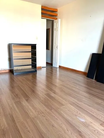 a view of room with wooden floor