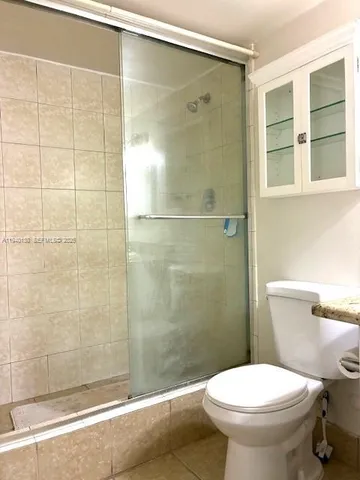 a bathroom with a toilet and a shower
