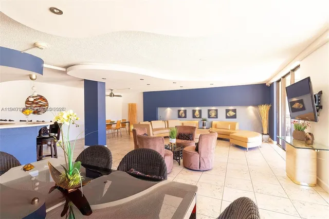 a living room with furniture a rug and a flat screen tv
