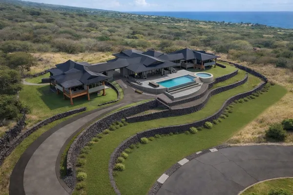 an aerial view of a house with a ocean view