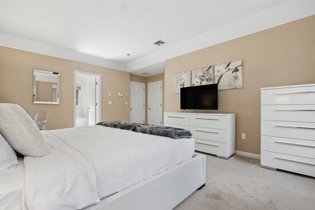 10 Burnett Road Southborough, MA 01772 - Photo 22 of 42 a bedroom with a bed and flat screen tv