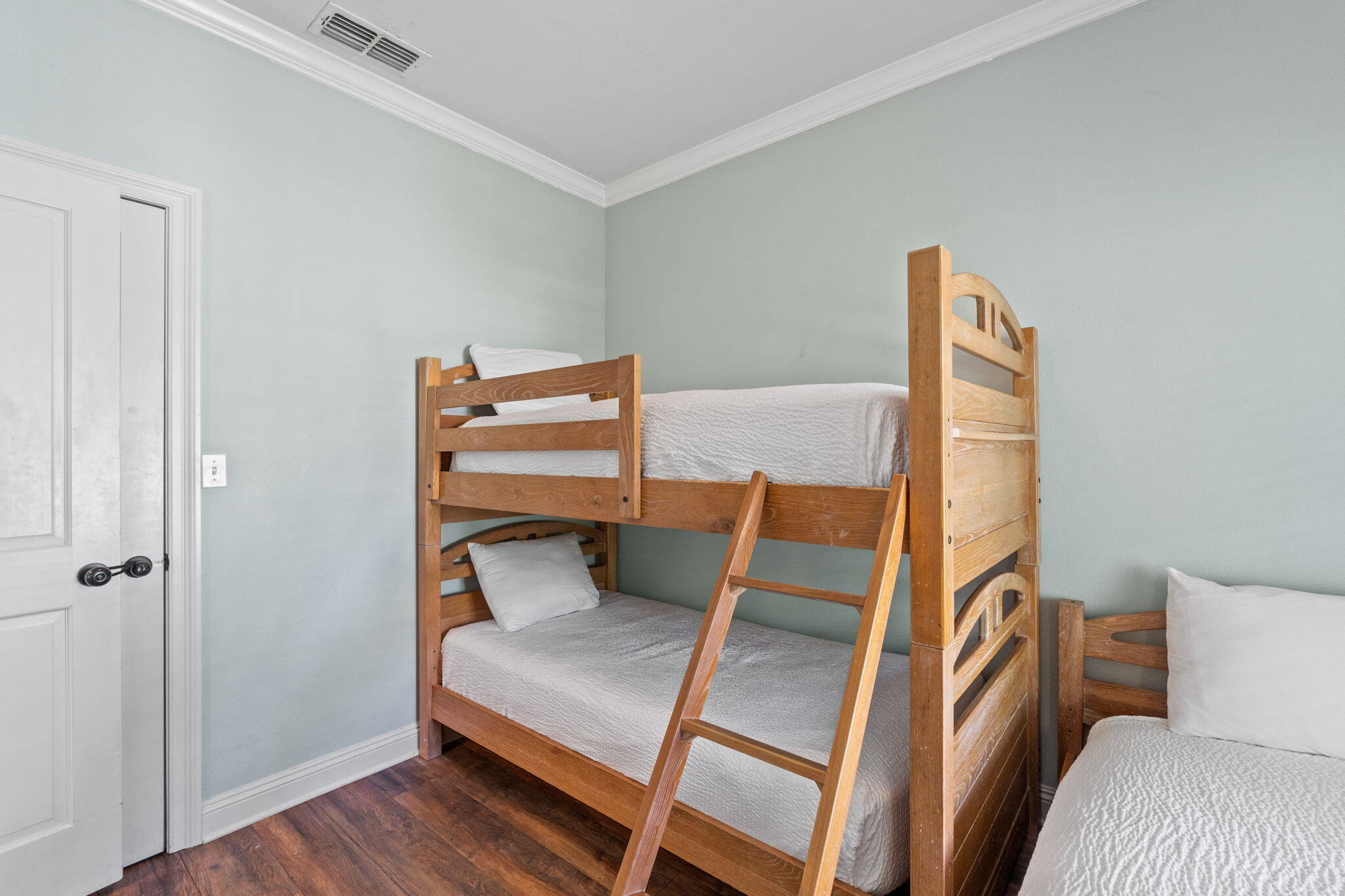 209 Grand Key Loop East Destin, FL 32541 - Photo 47 of 59 a bedroom with a bed and wooden floor