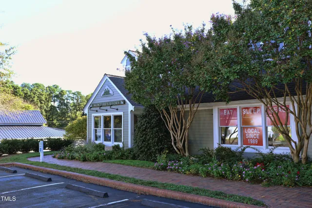 a view of a swimming pool with a big yard and large trees
