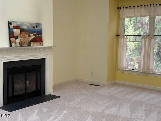 a living room with a fireplace and a window