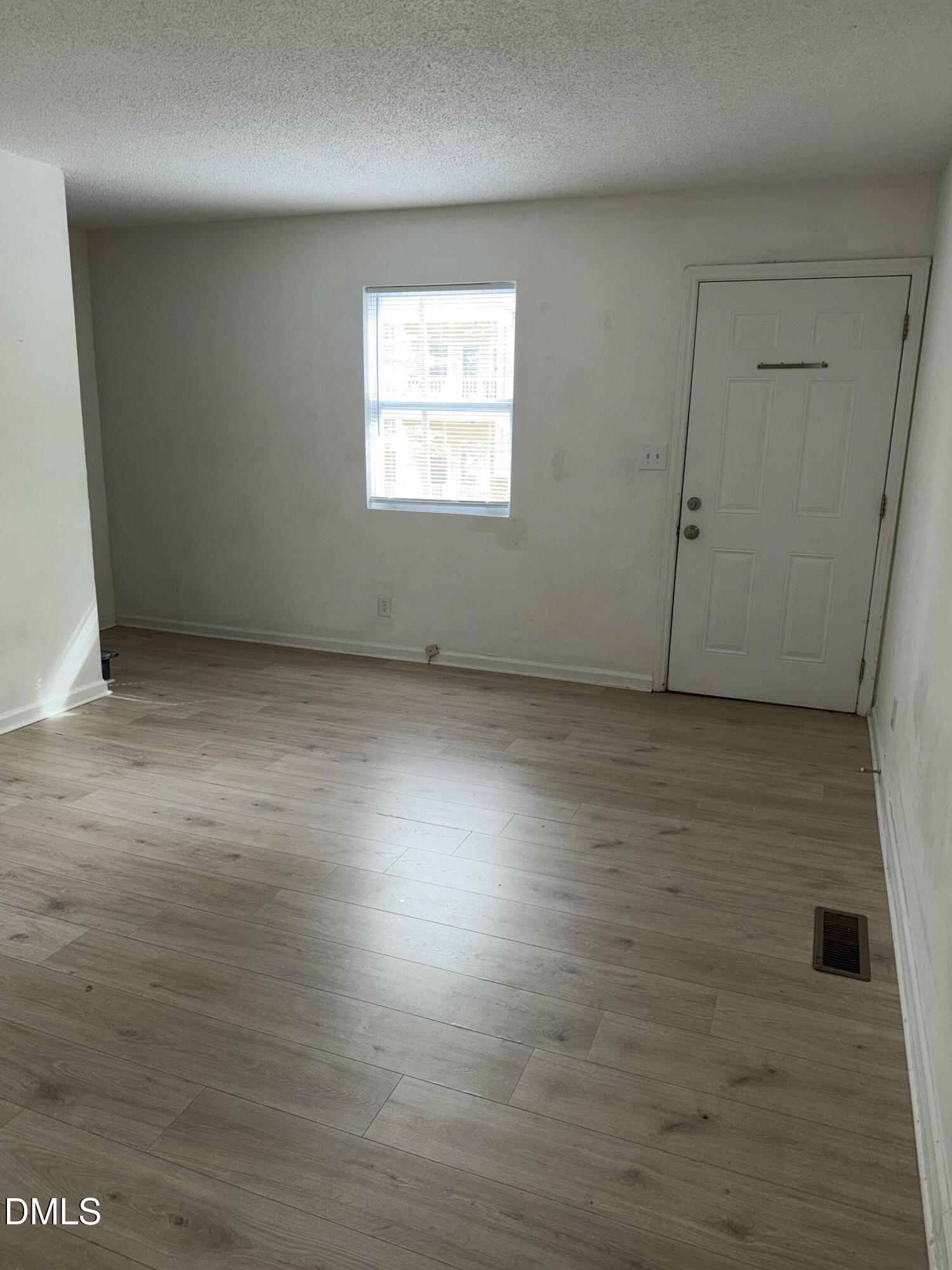 1107 Worth Street Durham, NC 27701 - Photo 11 of 17 an empty room with wooden floor and windows