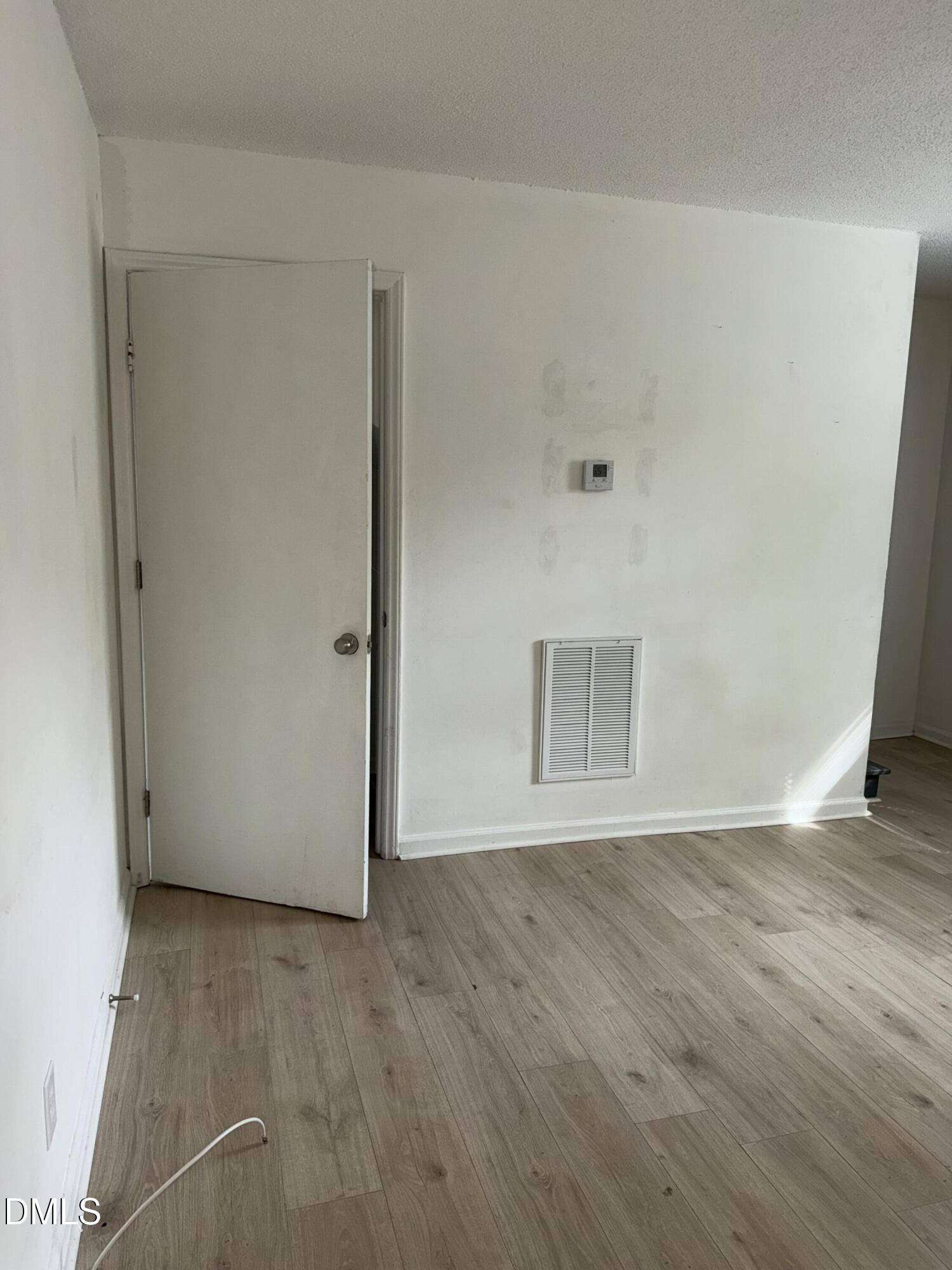 1107 Worth Street Durham, NC 27701 - Photo 12 of 17 a view of an empty room with wooden floor and a window