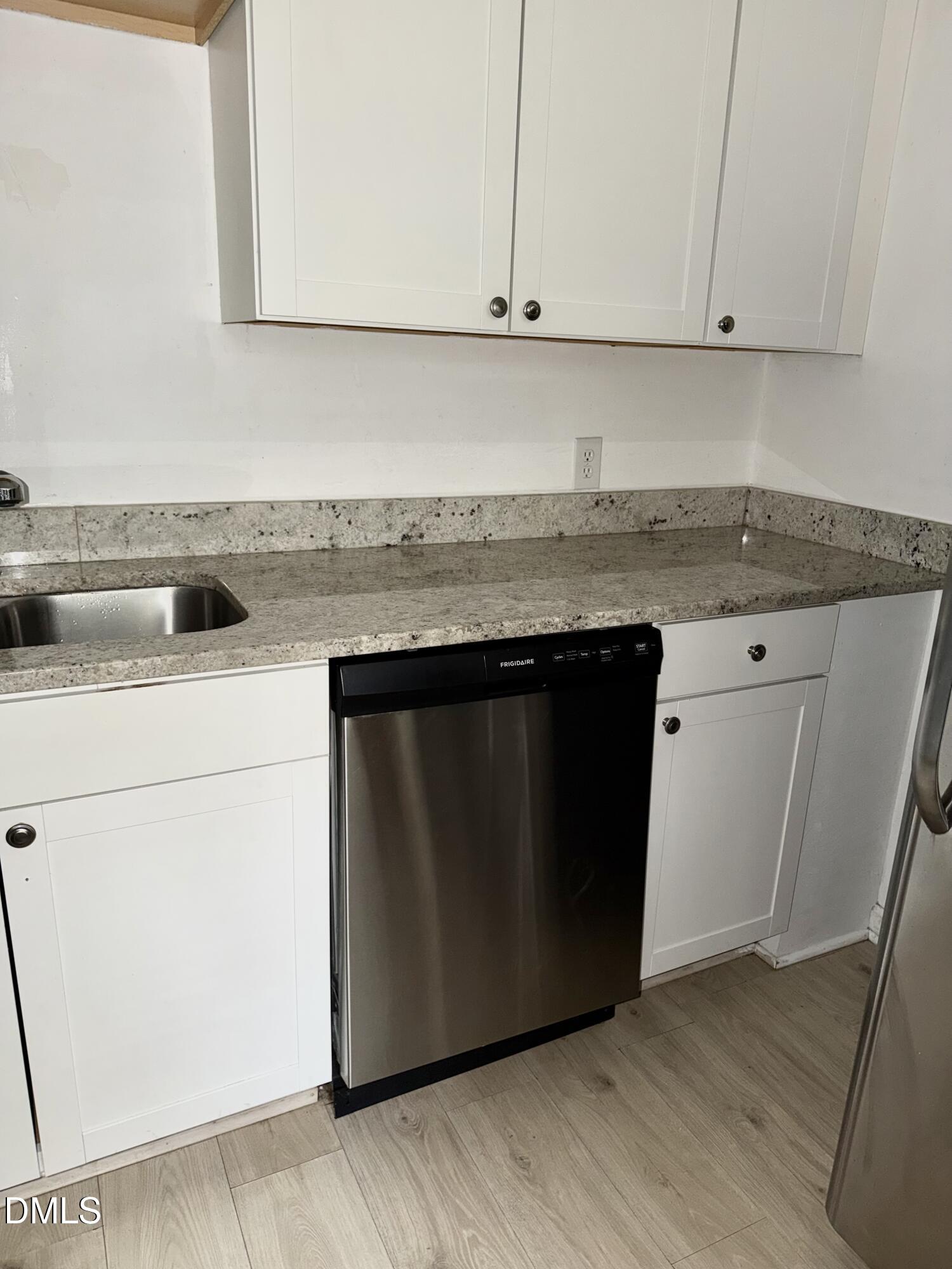 1107 Worth Street Durham, NC 27701 - Photo 14 of 17 a kitchen with granite countertop cabinets sink and white stainless steel appliances