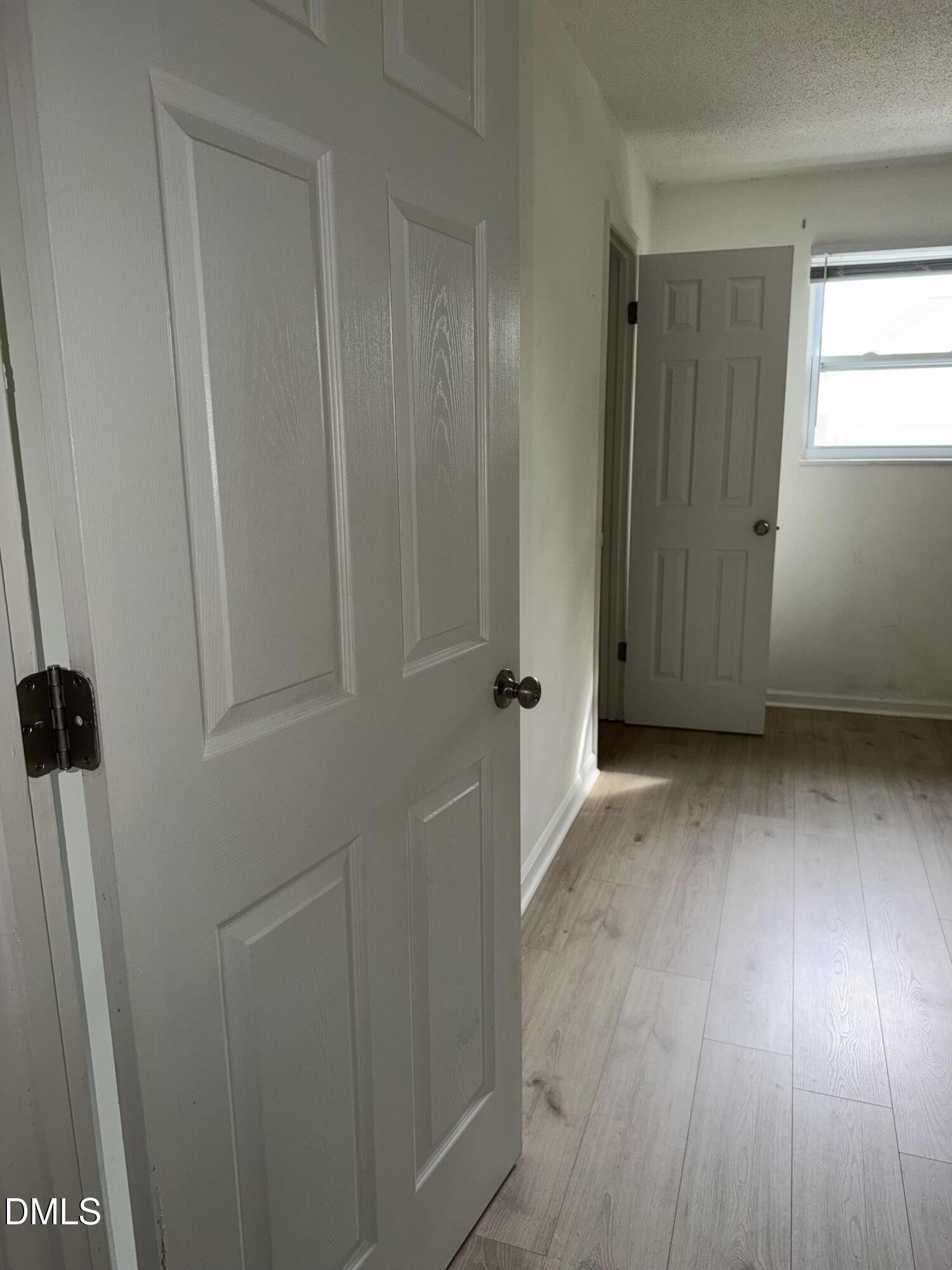 1107 Worth Street Durham, NC 27701 - Photo 10 of 17 an empty room with wooden floor and windows