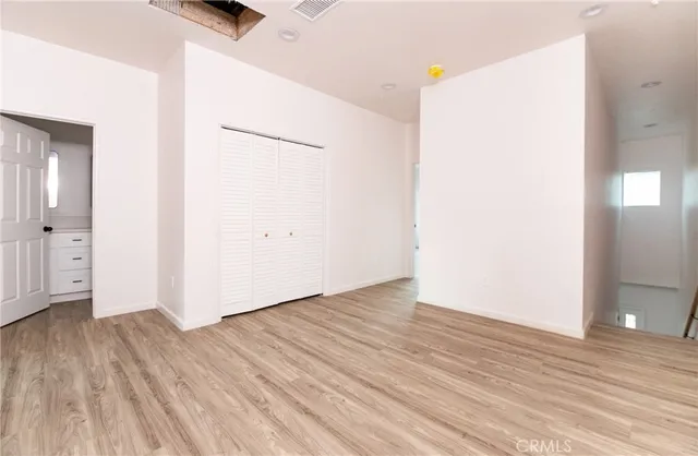 an empty room with wooden floor