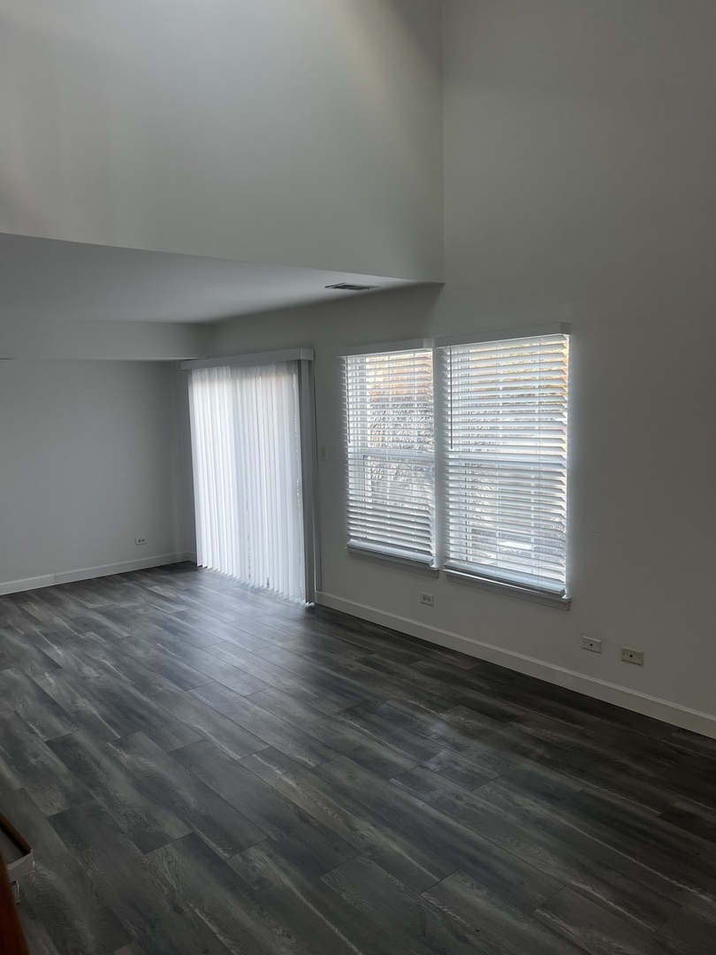 640 Beaver Court Naperville, IL 60563 - Photo 15 of 26 an empty room with wooden floor and windows