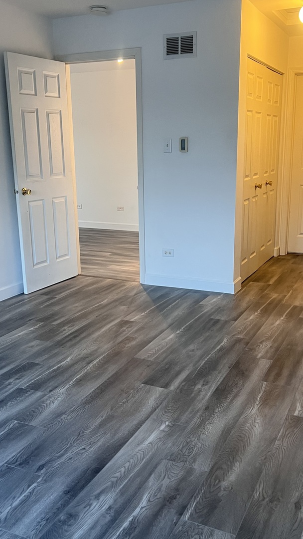 640 Beaver Court Naperville, IL 60563 - Photo 22 of 26 an empty room with wooden floor