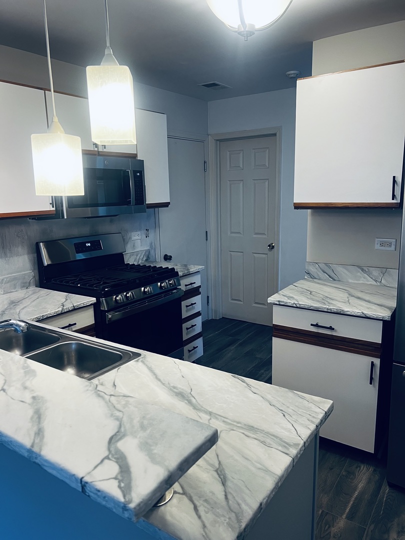 640 Beaver Court Naperville, IL 60563 - Photo 7 of 26 a kitchen with kitchen island a sink appliances and cabinets