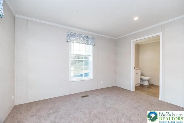 an empty room with a bathroom and a sink