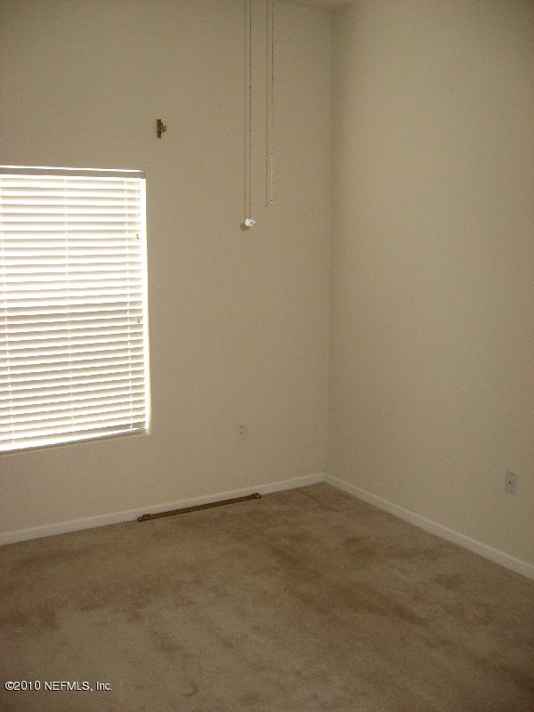 7920 Merrill Road, Unit 602 Jacksonville, FL 32277 - Photo 7 of 12 an empty room with a window