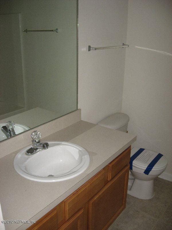 7920 Merrill Road, Unit 602 Jacksonville, FL 32277 - Photo 9 of 12 a bathroom with a sink and a toilet
