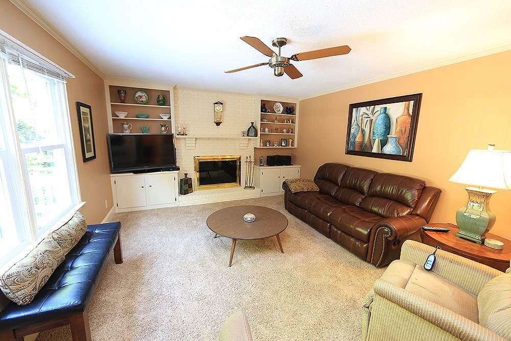 7905 Hardwick Drive Raleigh, NC 27615 - Photo 9 of 26 The family room has lots of windows! Pretty fireplace and bookshelves, there is a game/coat closet too. Family Room
