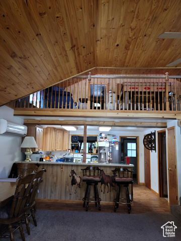 97 East Main Street Stockton, UT 84071 - Photo 35 of 58 Kitchen featuring a wall mounted AC, lofted ceiling, wood ceiling, stainless steel fridge, and carpet