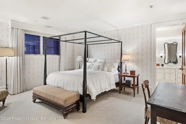 a spacious bedroom with a bed and furniture