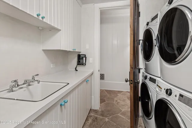 a view of a roof deck with couches under an umbrella