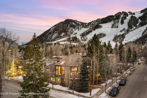a living room with furniture a chandelier and a dining room