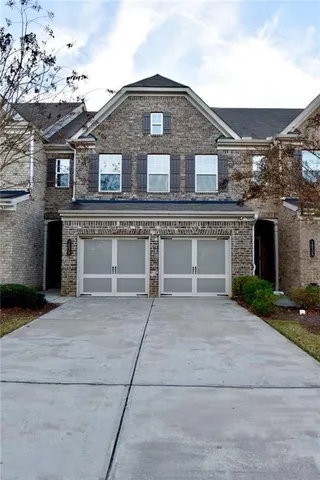 a front view of a house with yard