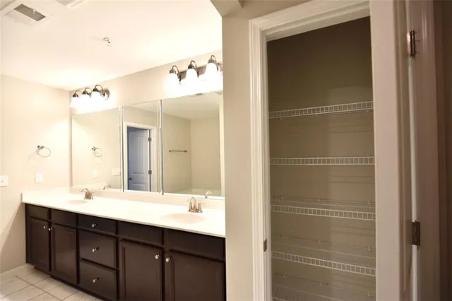 a bathroom with a double vanity sink and mirror